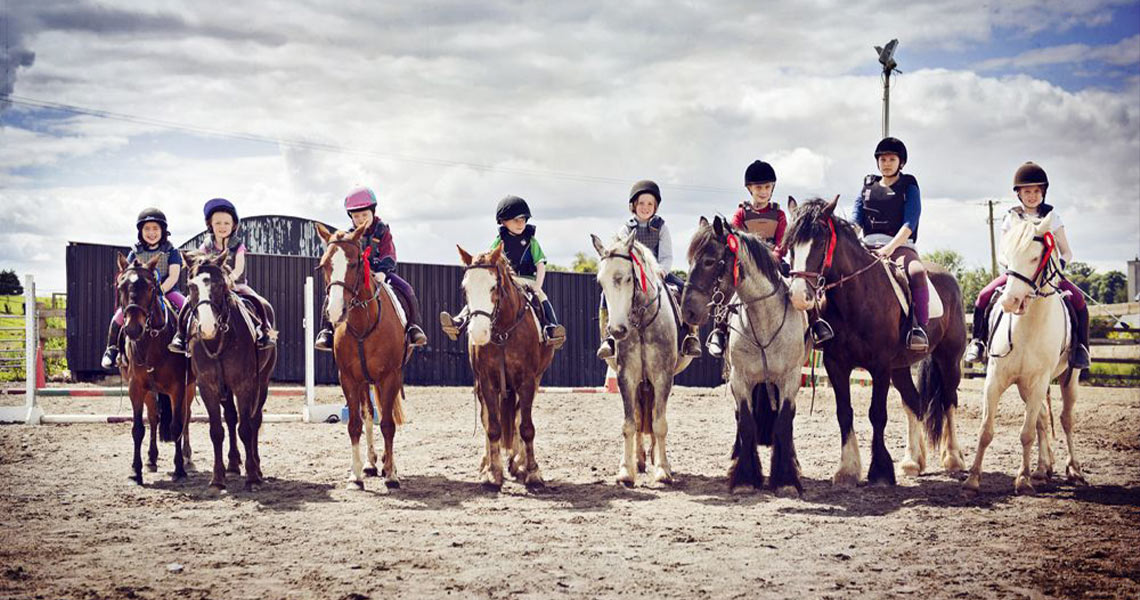 Group of children ready for a lesson at Athlone Equestrian Centre.