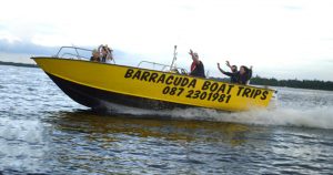 Barracuda Boat Trips boat speeding across the lake.