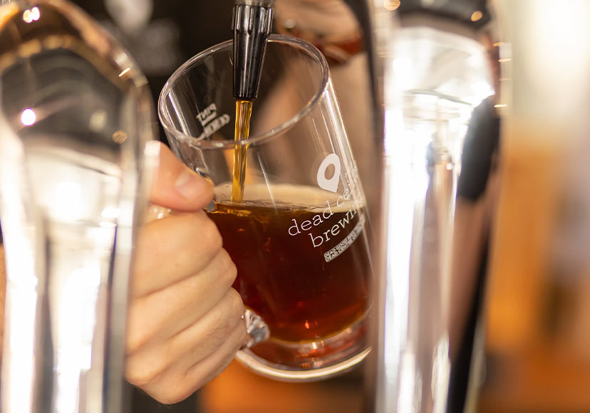 Bartender pouring a pint at Dead Centre Brewing.