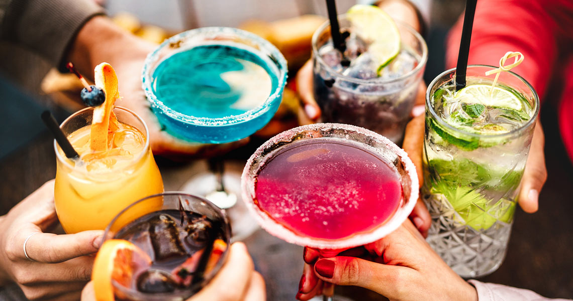 Group of women showing their various cocktails from Maisie's.