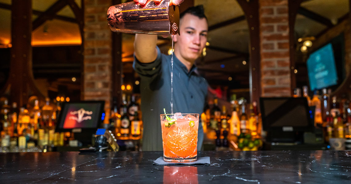 Bartender pouring a cocktail at The Prince Bar.