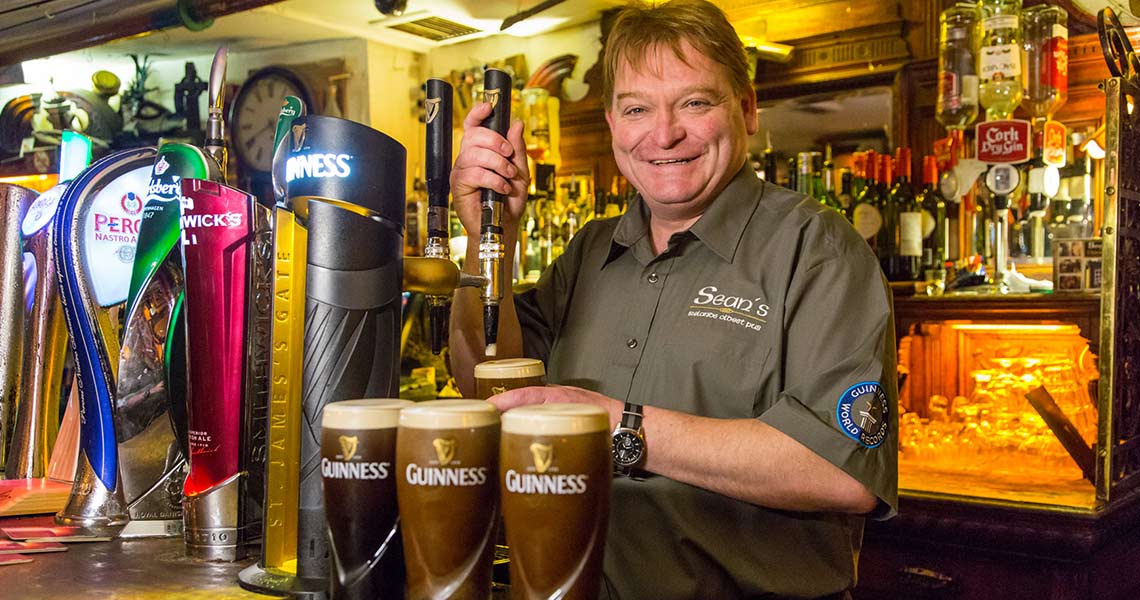 Bartender pouring a Guinness at Sean's Bar