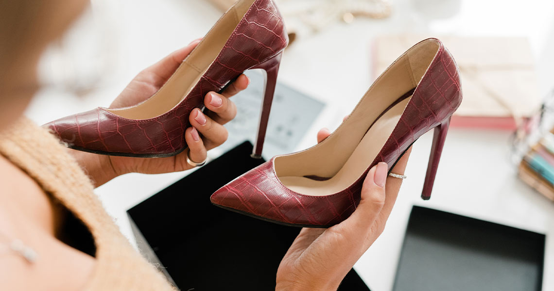 Woman picking shoes at Lusana Shoe Boutique.