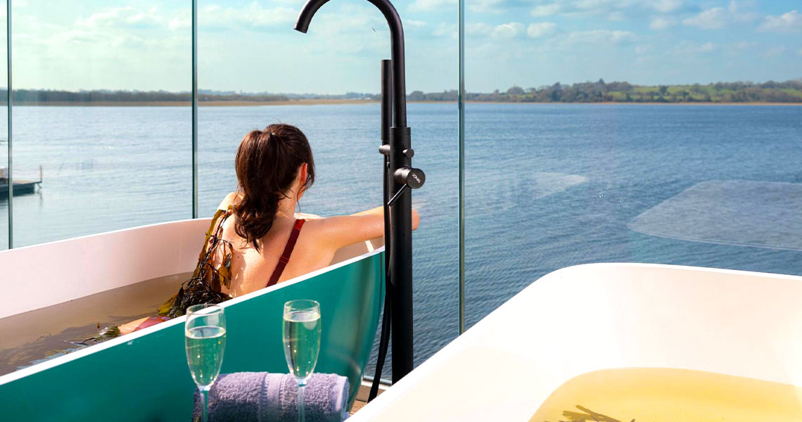 Woman enjoying relaxing outdoor seaweed bath at the Cedarwood Spa.